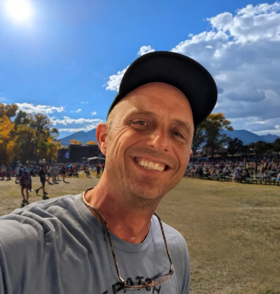 Derek Hogeland smiling outdoors at a concert